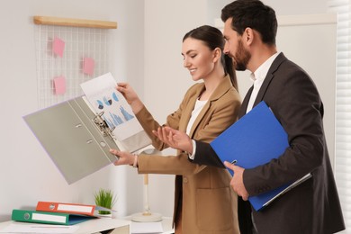 Photo of Businesspeople working together with charts in office