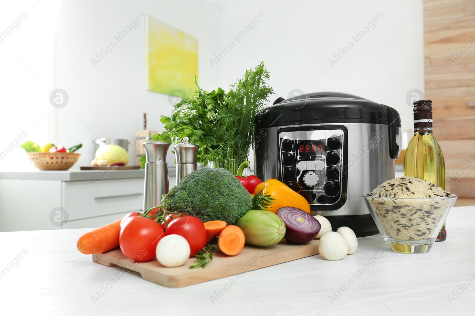 Photo of Modern multi cooker and products on kitchen table