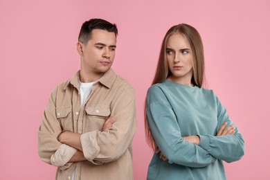 Photo of Portrait of resentful couple with crossed arms on pink background