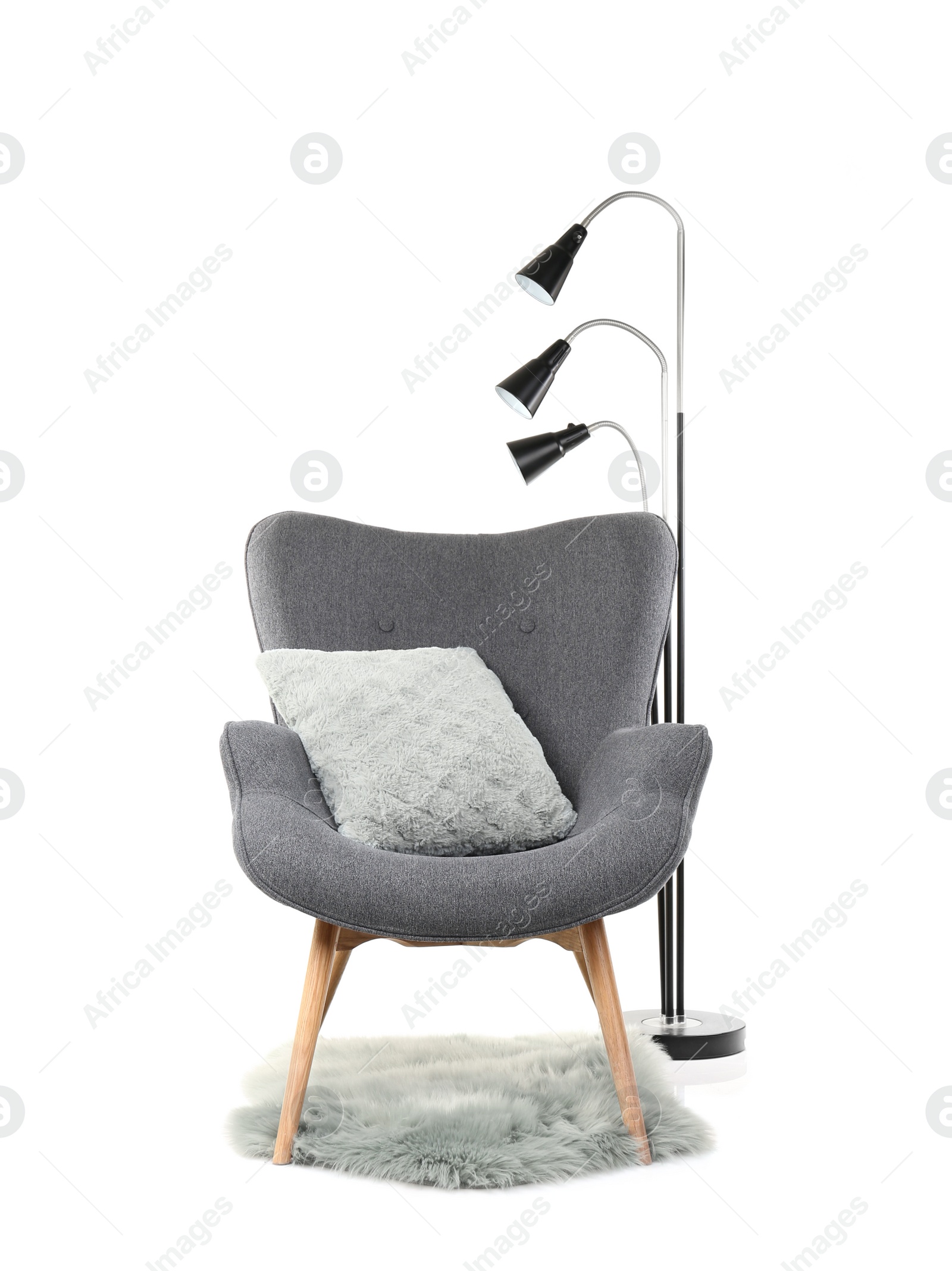 Photo of Comfortable armchair with pillow and rug on white background