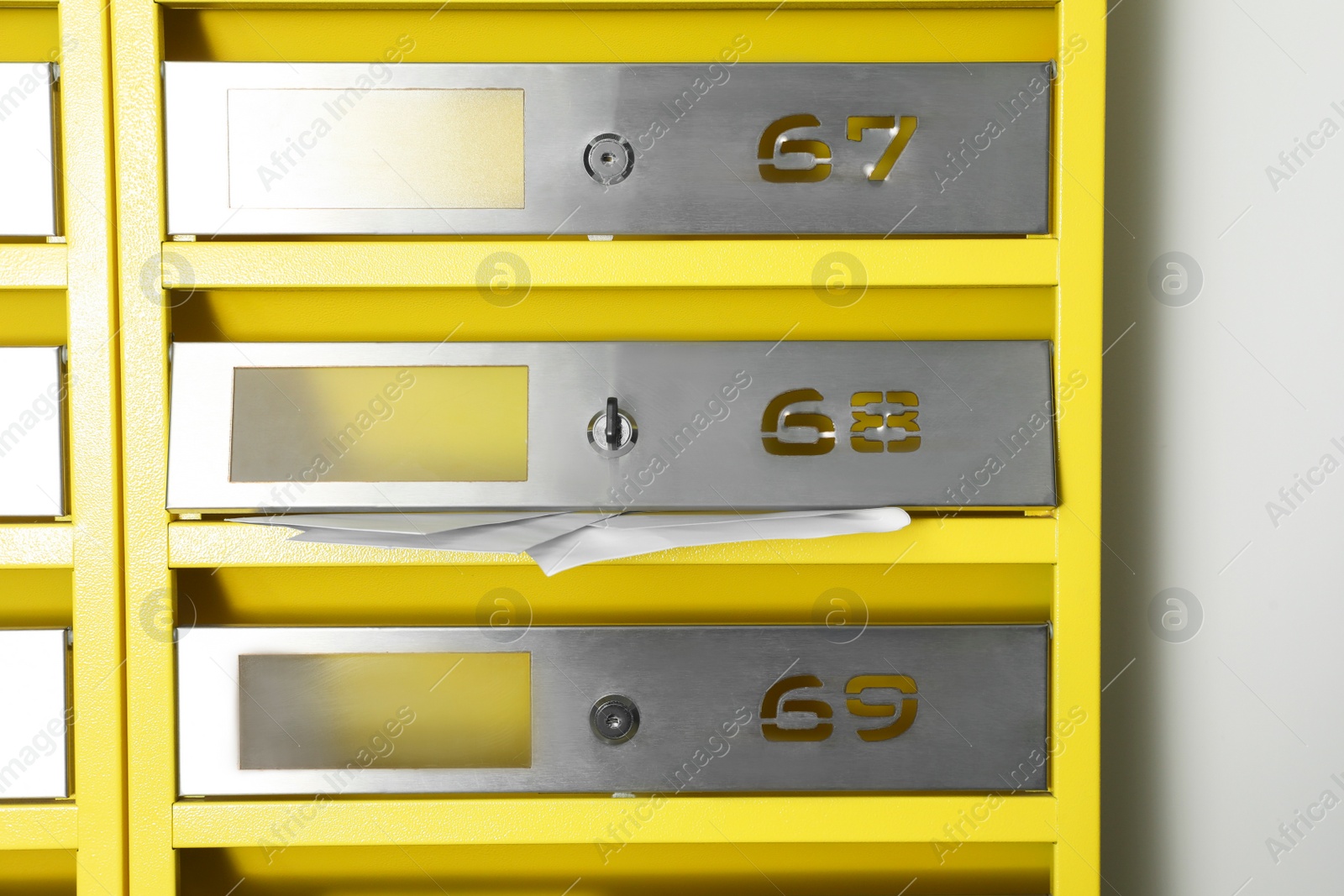 Photo of Metal mailboxes with keyholes, numbers and receipts in post office