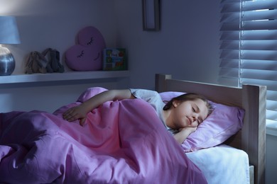 Cute little girl sleeping in bed at home