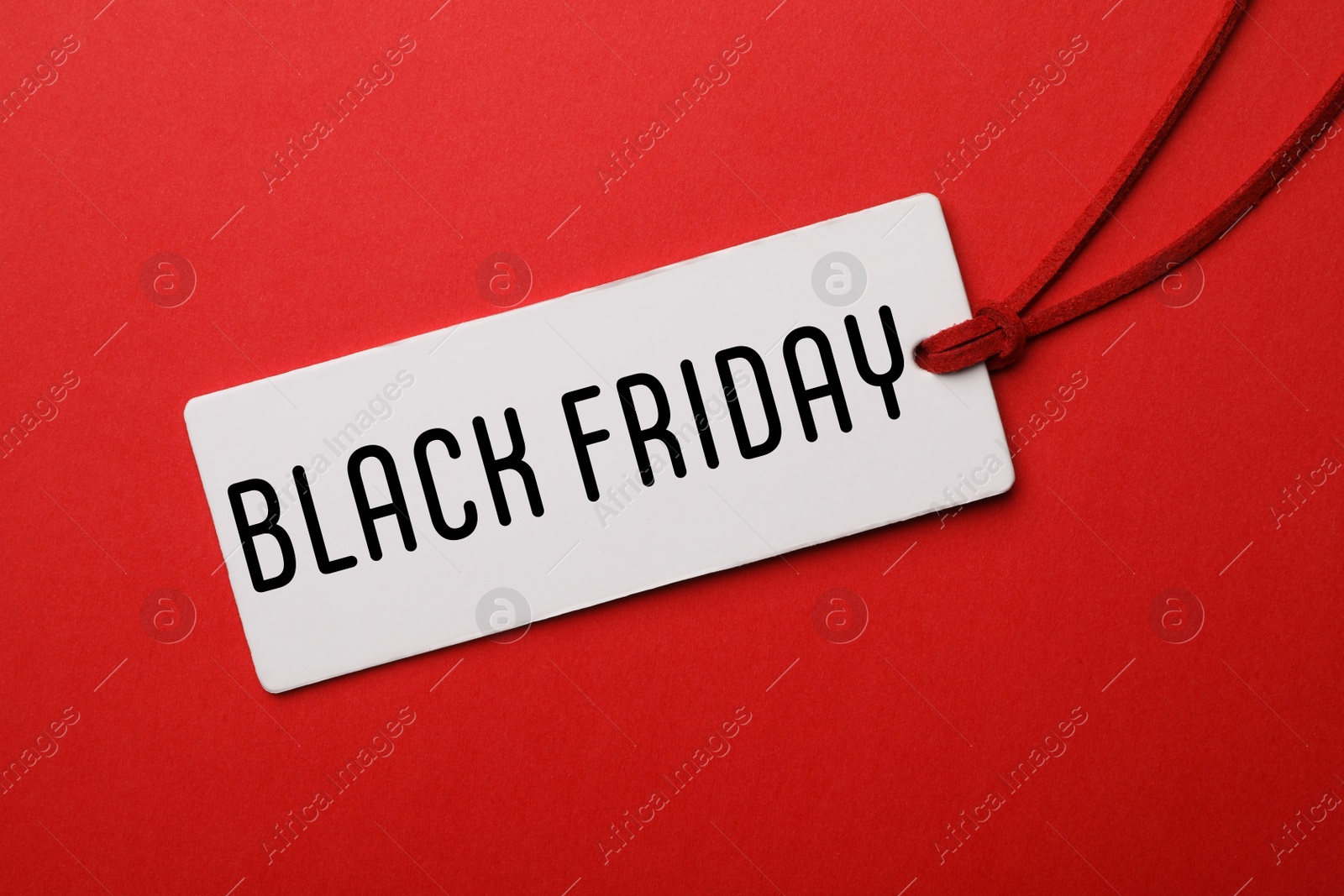 Image of Tag with text BLACK FRIDAY on red background, top view
