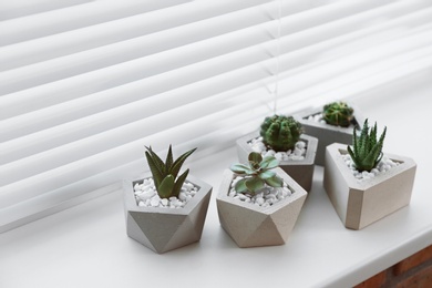 Photo of Window with blinds and potted plants on sill