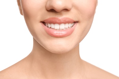 Photo of Young woman with beautiful smile on white background, closeup. Teeth whitening