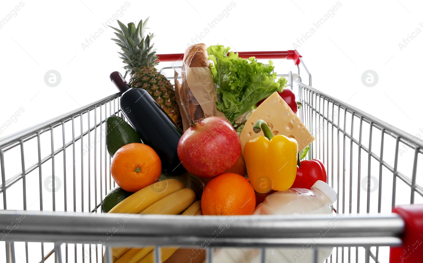 Photo of Shopping cart with groceries on white background, closeup