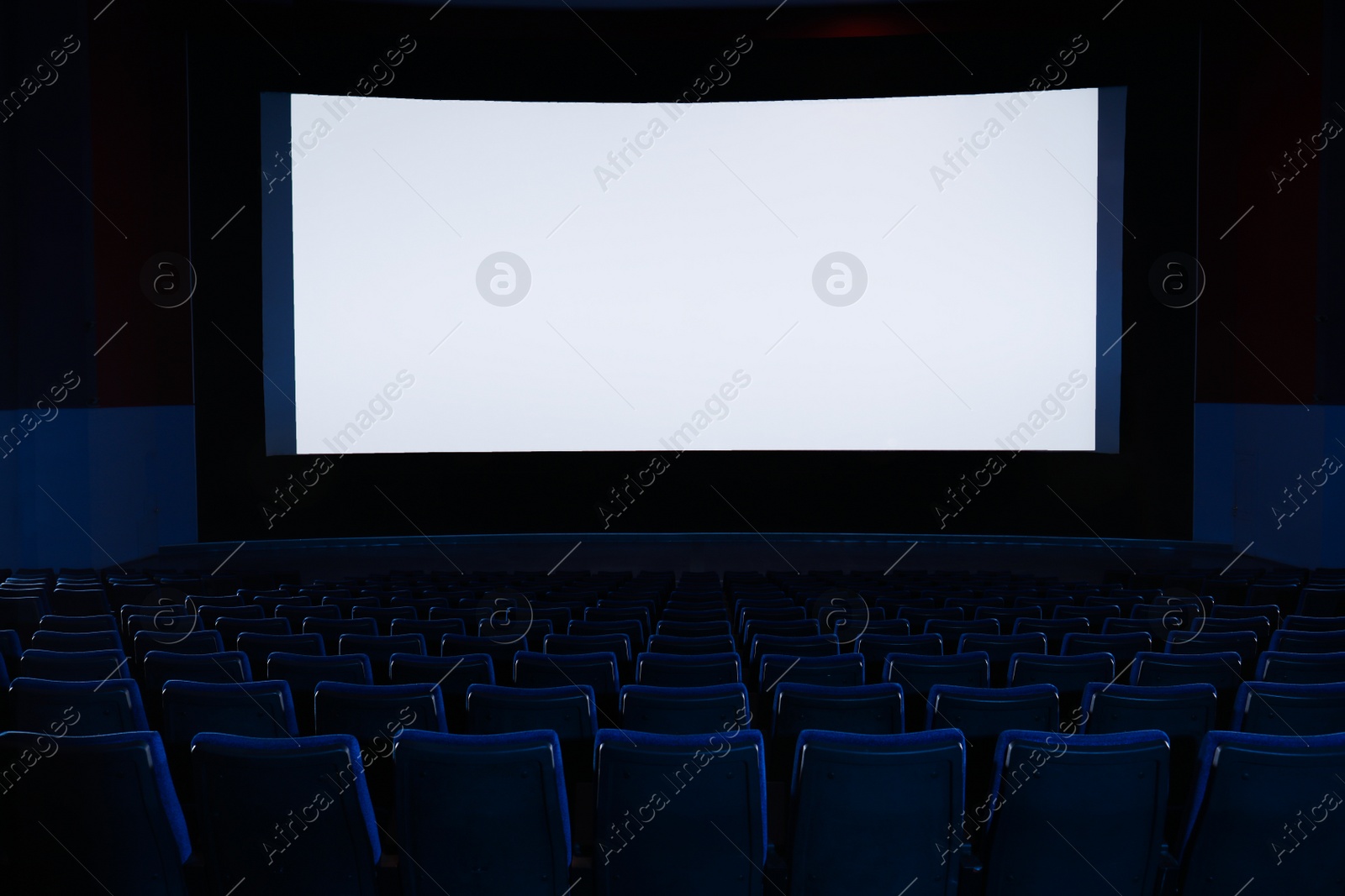 Photo of Empty cinema with large screen and comfortable chairs. Space for text