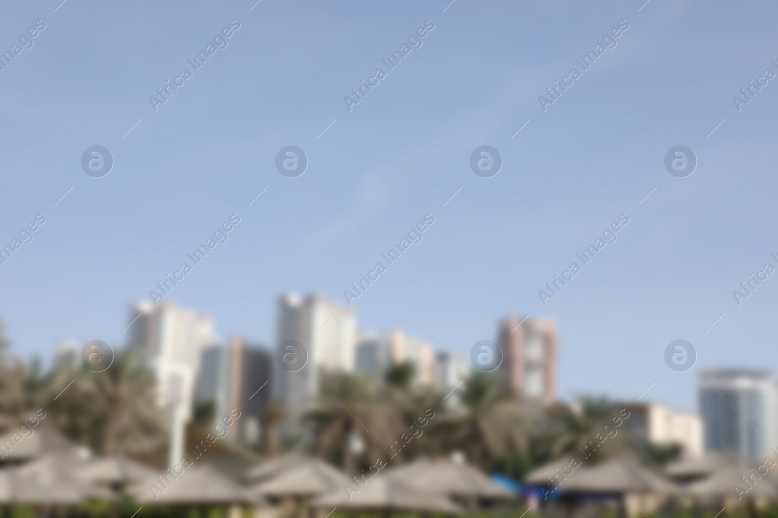 Photo of AJMAN, UNITED ARAB EMIRATES - NOVEMBER 04, 2018: Landscape with modern high buildings on sunny day, blurred view