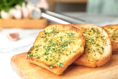 Photo of Slices of toasted bread with garlic and herbs on table