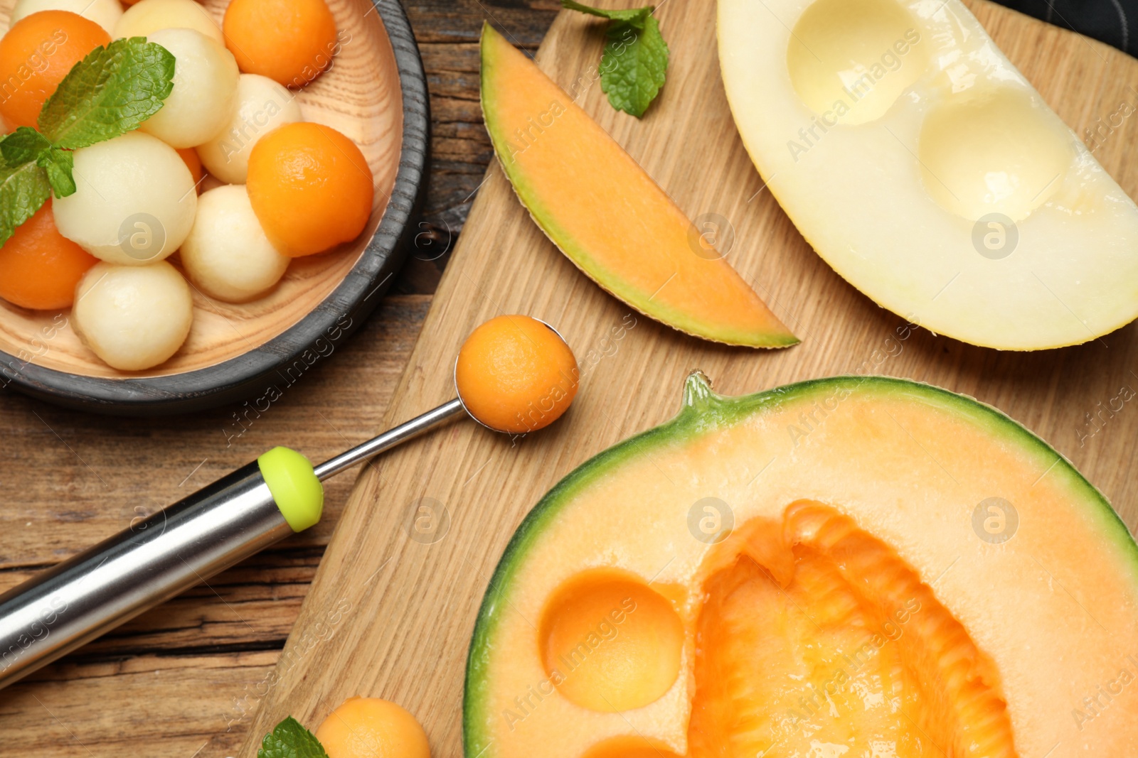 Photo of Flat lay composition with melon balls on wooden table