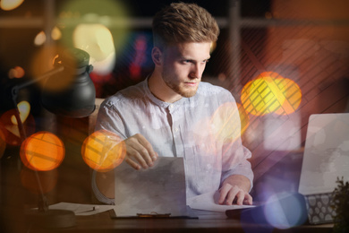 Image of Double exposure of young man working in office and cityscape. Financial analytics