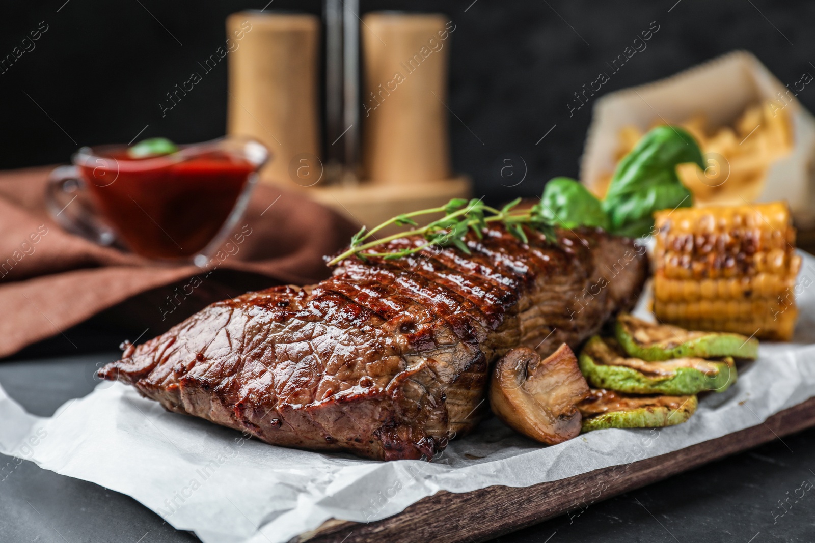 Photo of Delicious beef tenderloin served on table, closeup