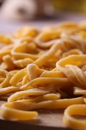 Homemade pasta on blurred background, closeup view
