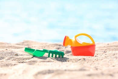 Photo of Children toys on sand near sea. Beach object