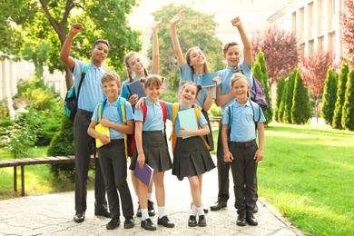 Photo of Group of children in stylish school uniform outdoors