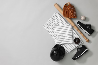 Photo of Flat lay composition with baseball uniform on white background. Space for text