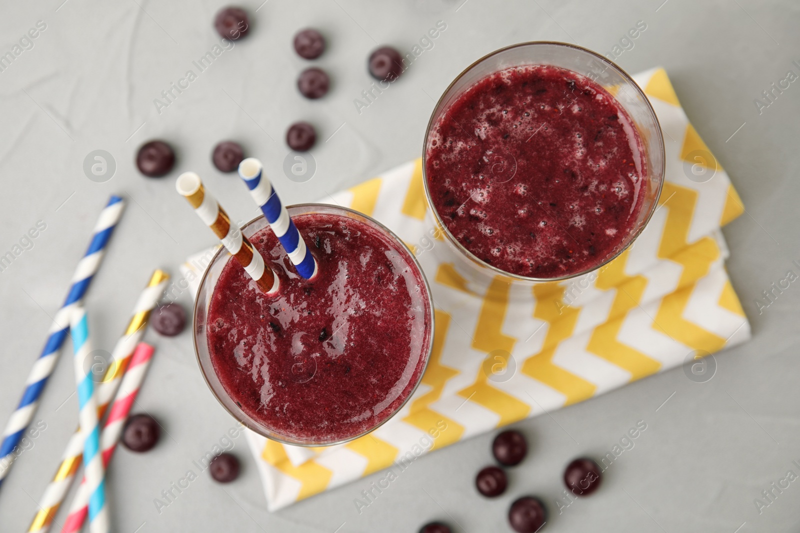 Photo of Glasses with delicious acai smoothie on table, top view