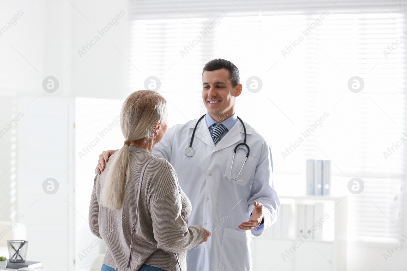 Photo of Doctor consulting patient in his office at hospital