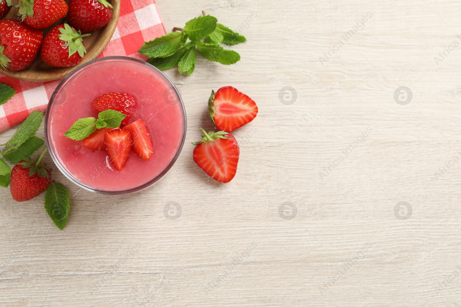 Photo of Delicious strawberry mousse with mint on white wooden table, flat lay. Space for text