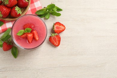 Delicious strawberry mousse with mint on white wooden table, flat lay. Space for text