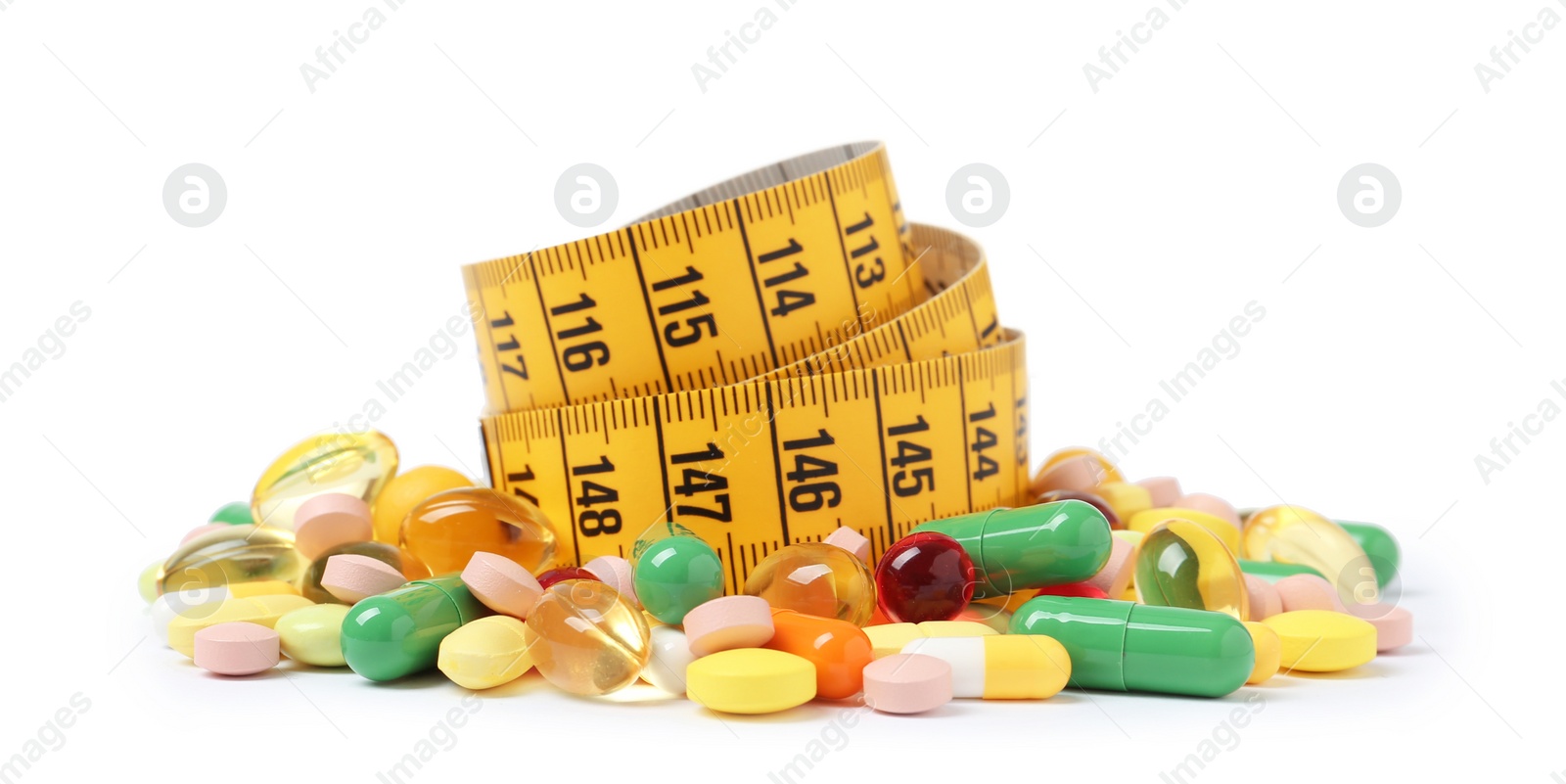 Photo of Weight loss pills and measuring tape on white background