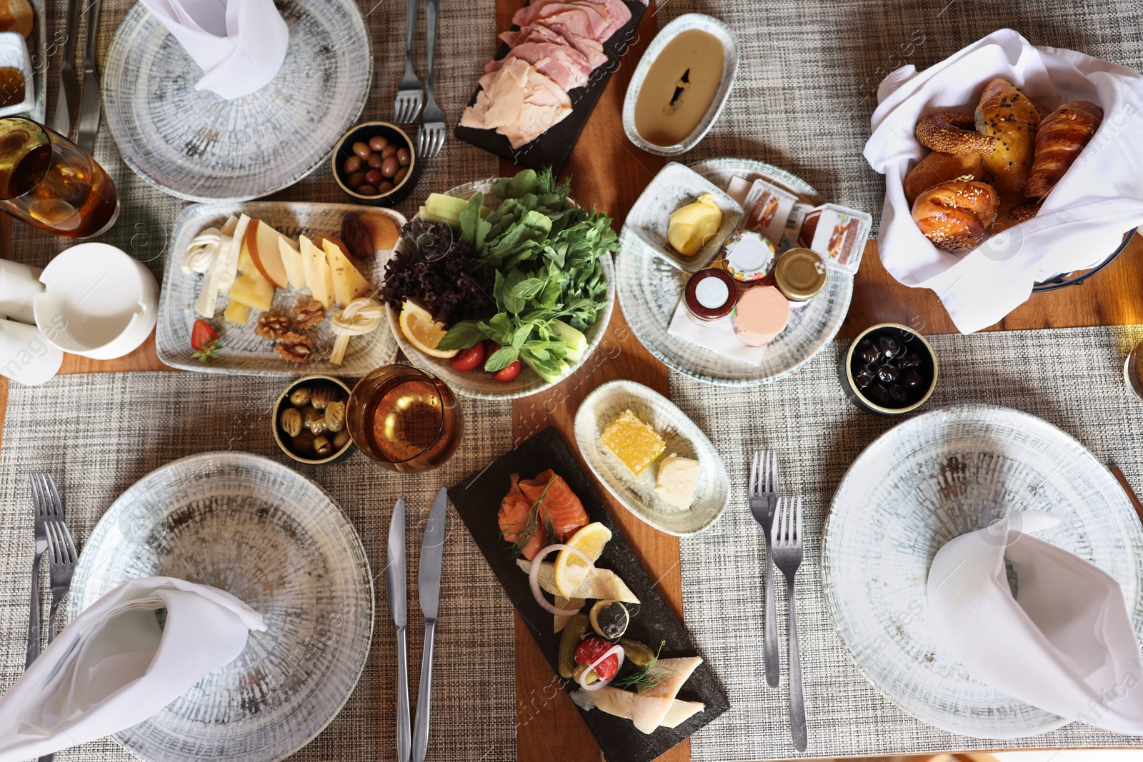 Photo of Different delicious food served on wooden table, flat lay