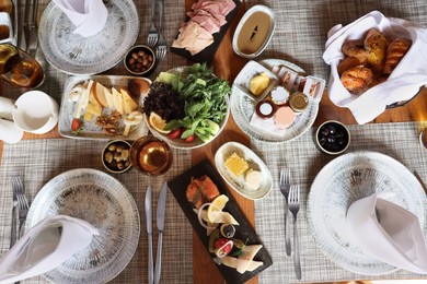 Different delicious food served on wooden table, flat lay