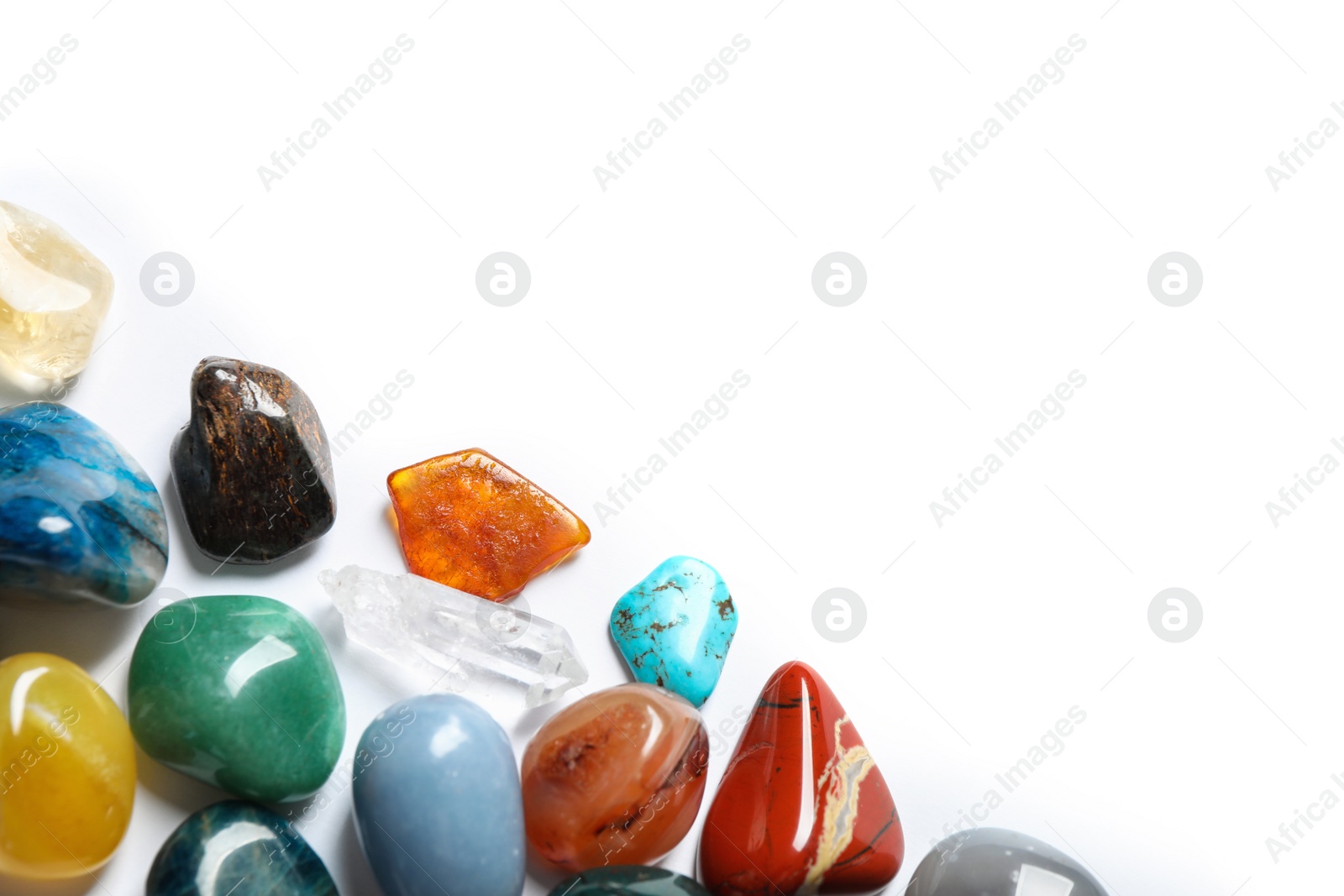 Photo of Different beautiful gemstones on white background, top view