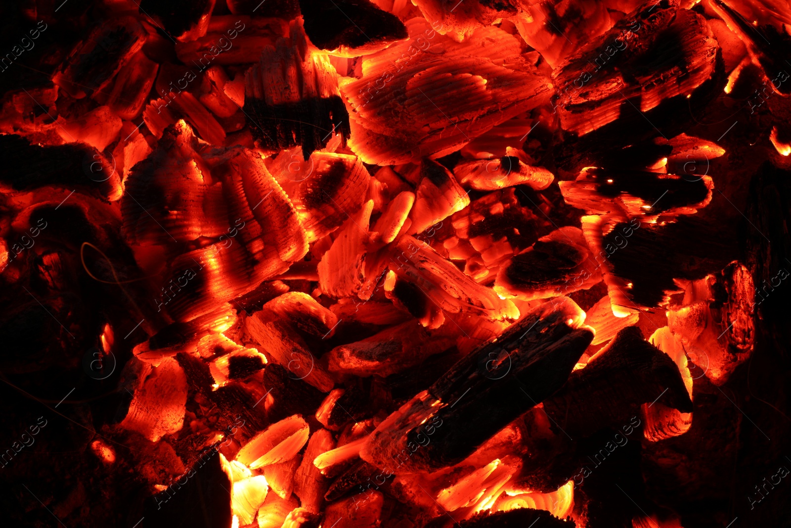 Photo of Pieces of hot smoldering coal as background, top view