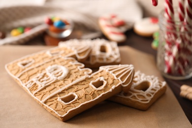 Parts of gingerbread house on parchment, closeup