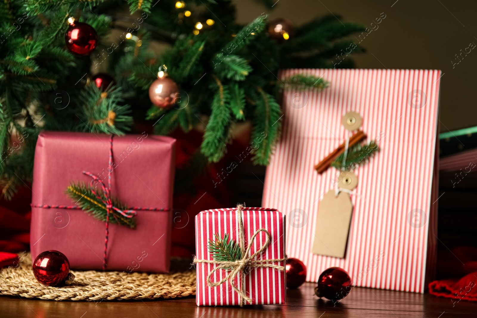 Photo of Composition with beautifully wrapped gift boxes on wooden table