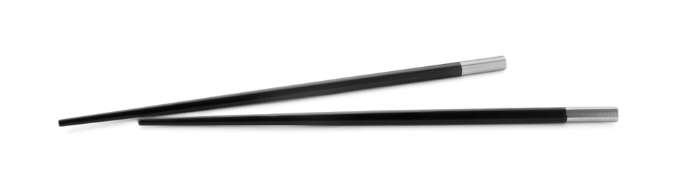 Pair of black chopsticks isolated on white