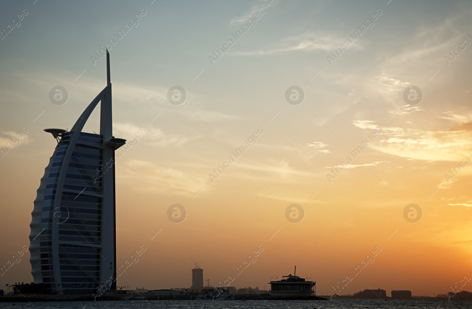 Photo of DUBAI, UNITED ARAB EMIRATES - NOVEMBER 03, 2018: Beautiful view of famous Burj Al Arab and amazing sunset sky