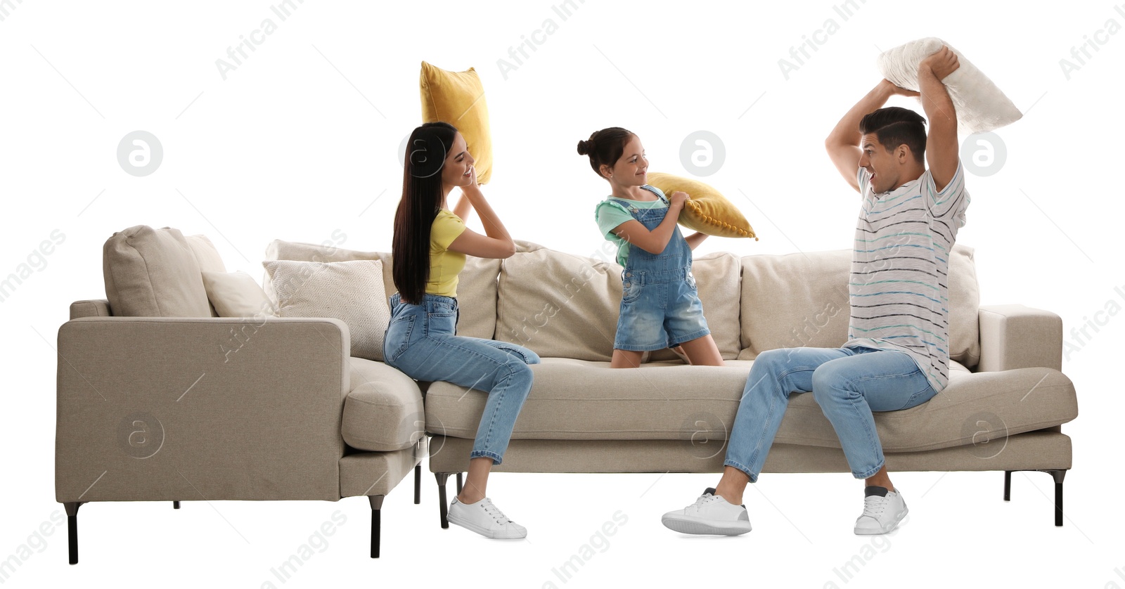 Photo of Happy family having pillow fight on comfortable sofa against white background