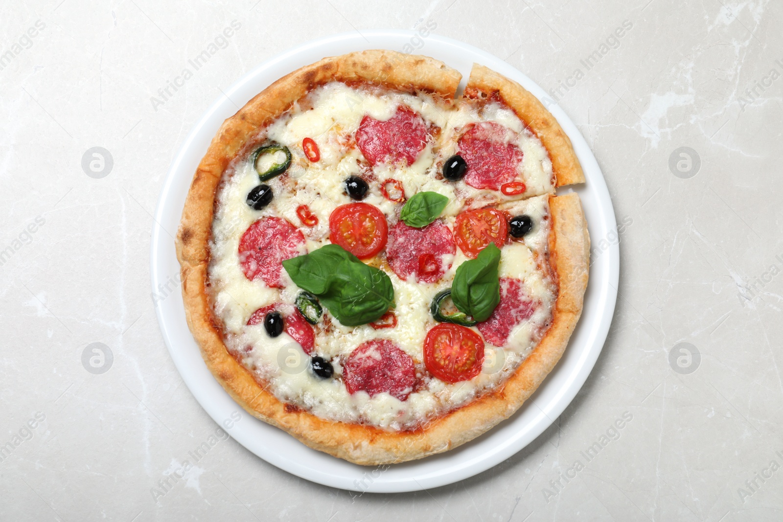 Photo of Delicious pizza Diablo on light marble background, top view