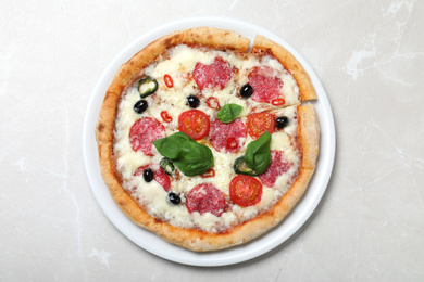 Delicious pizza Diablo on light marble background, top view