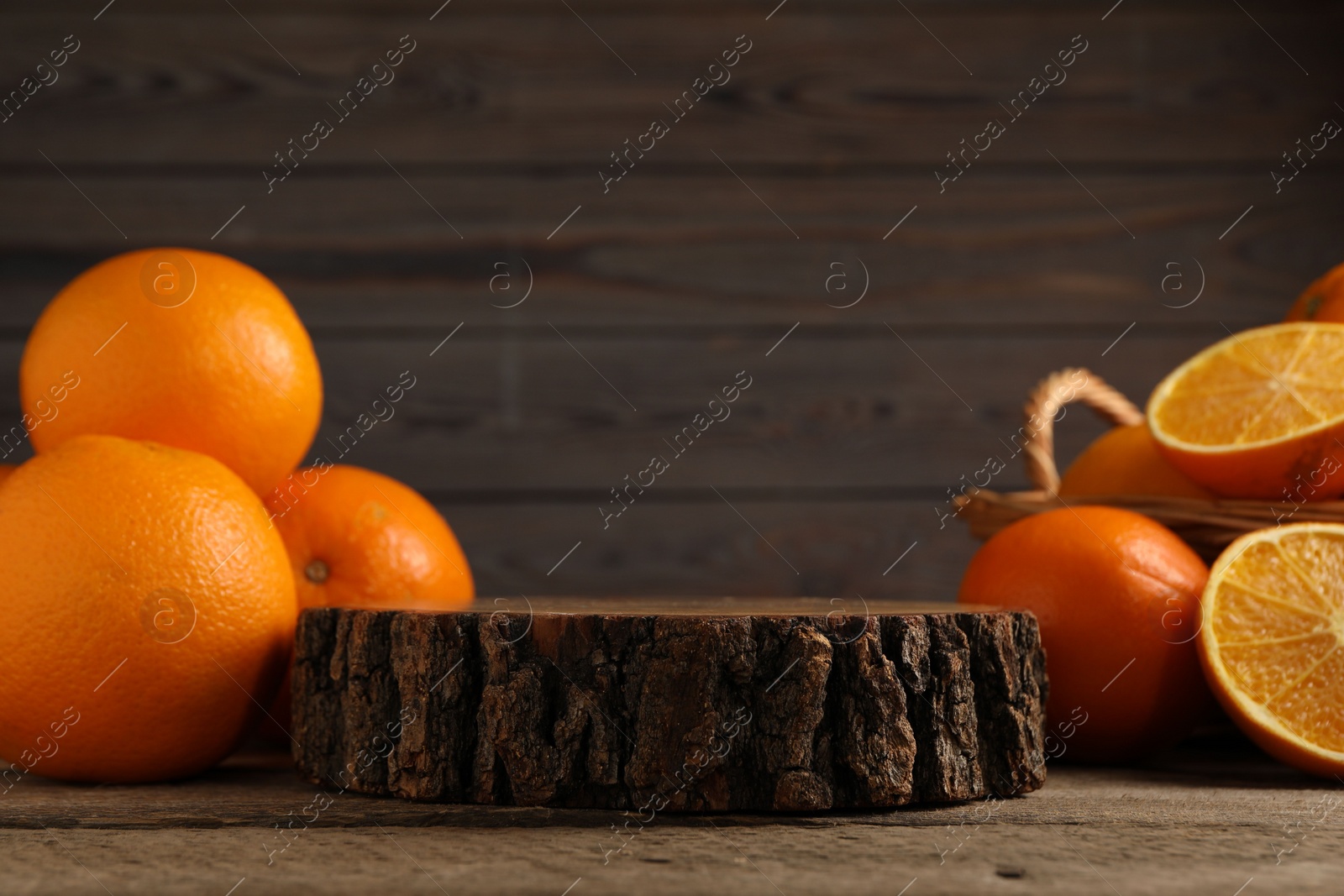 Photo of Fresh oranges on wooden table, space for text