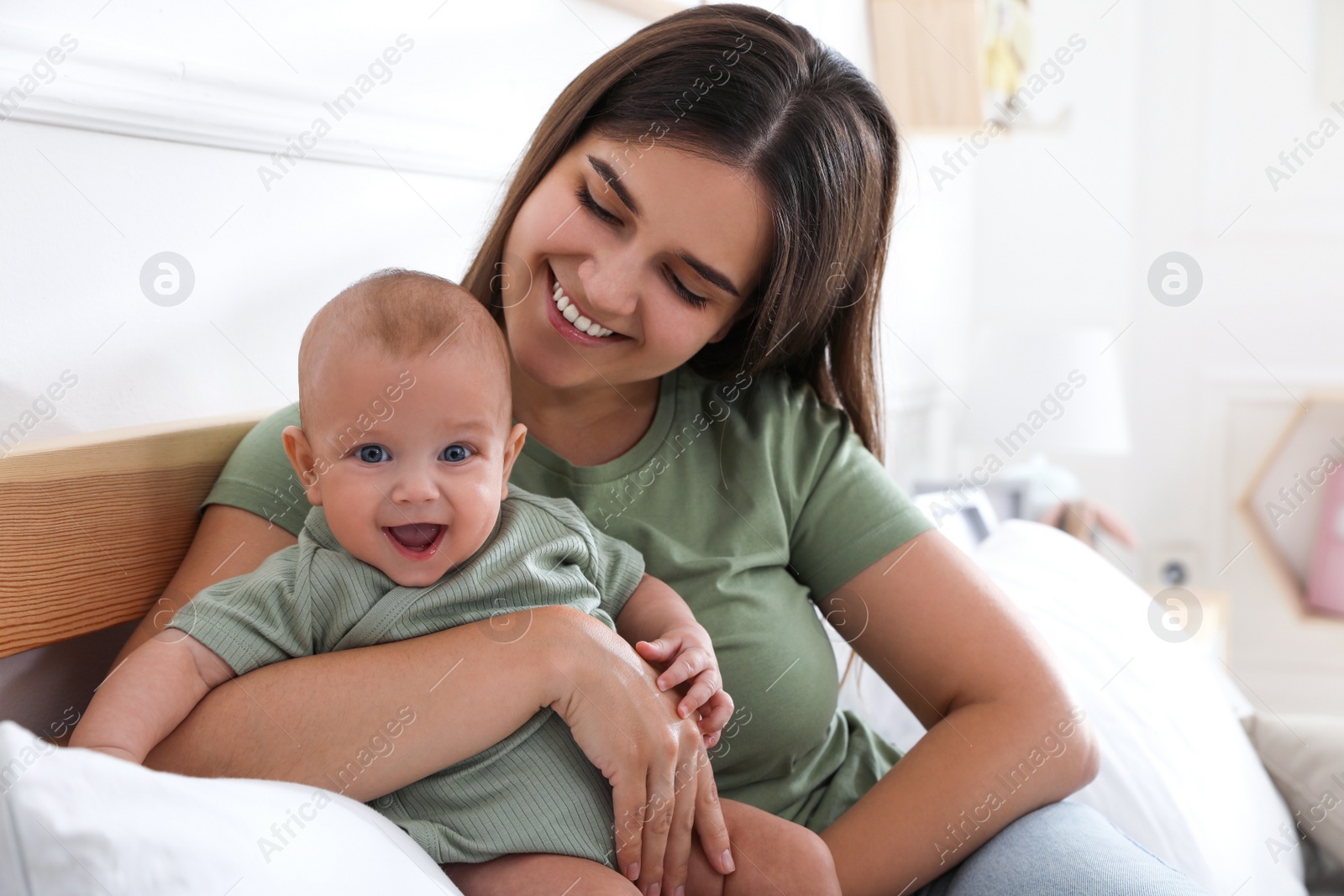 Photo of Mother with her cute baby at home