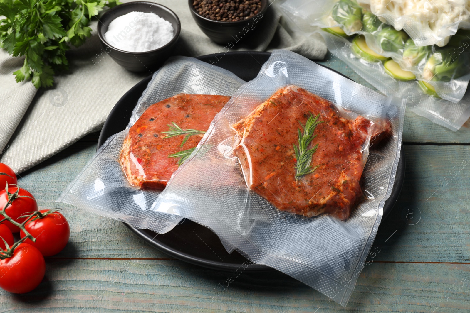 Photo of Meat in vacuum packings on wooden table