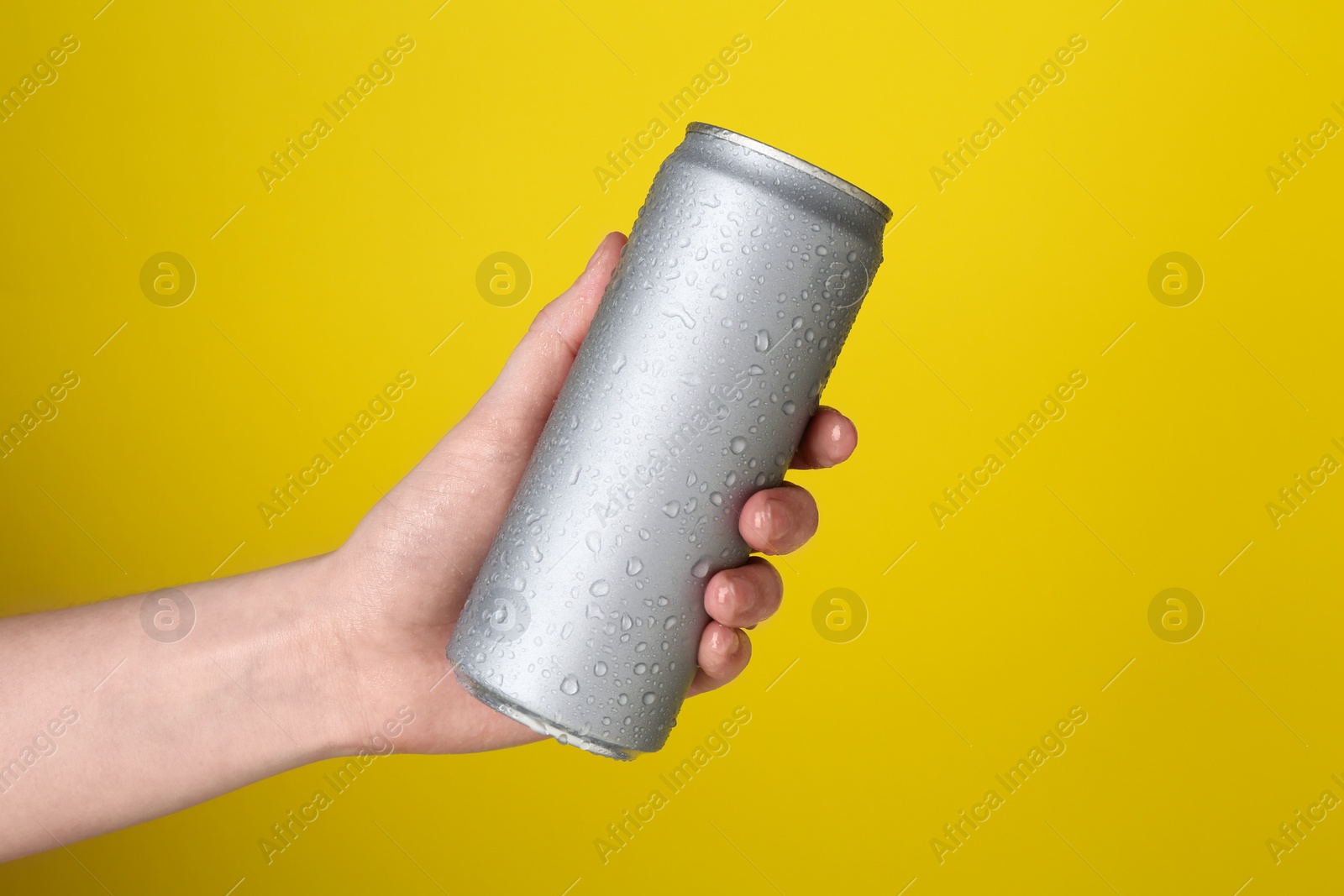 Photo of Woman with energy drink on yellow background, closeup