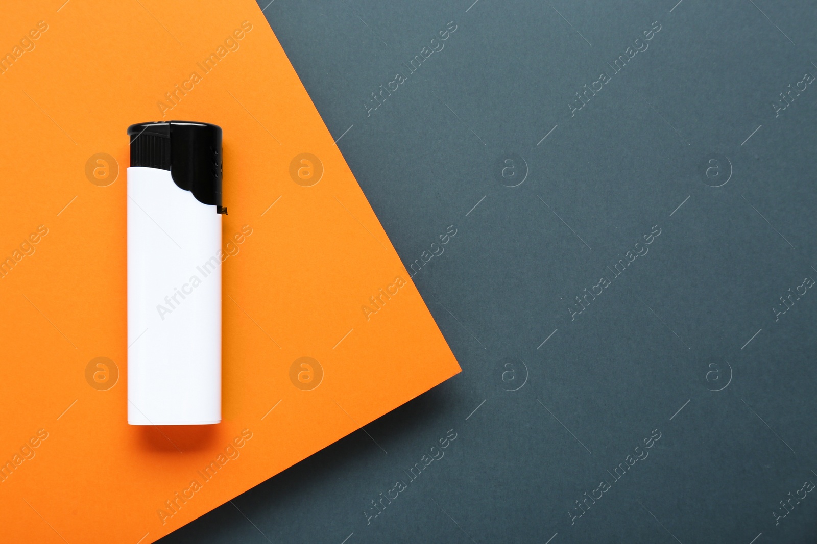 Photo of Stylish small pocket lighter on color background, top view. Space for text