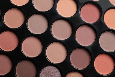 Beautiful eye shadow palette as background, top view