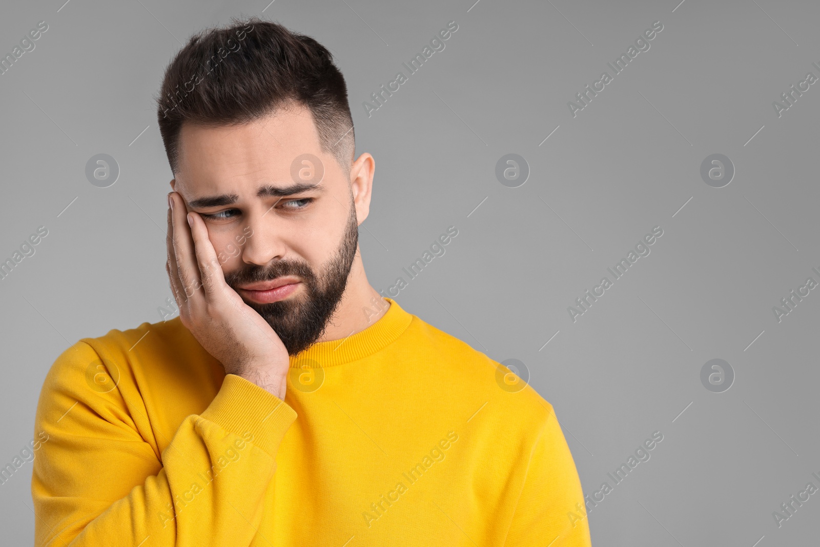 Photo of Portrait of sad man on light grey background, space for text