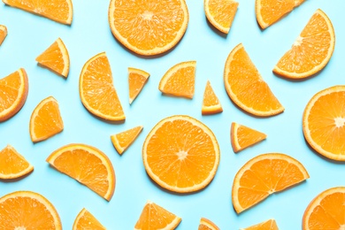 Flat lay composition with orange slices on color background