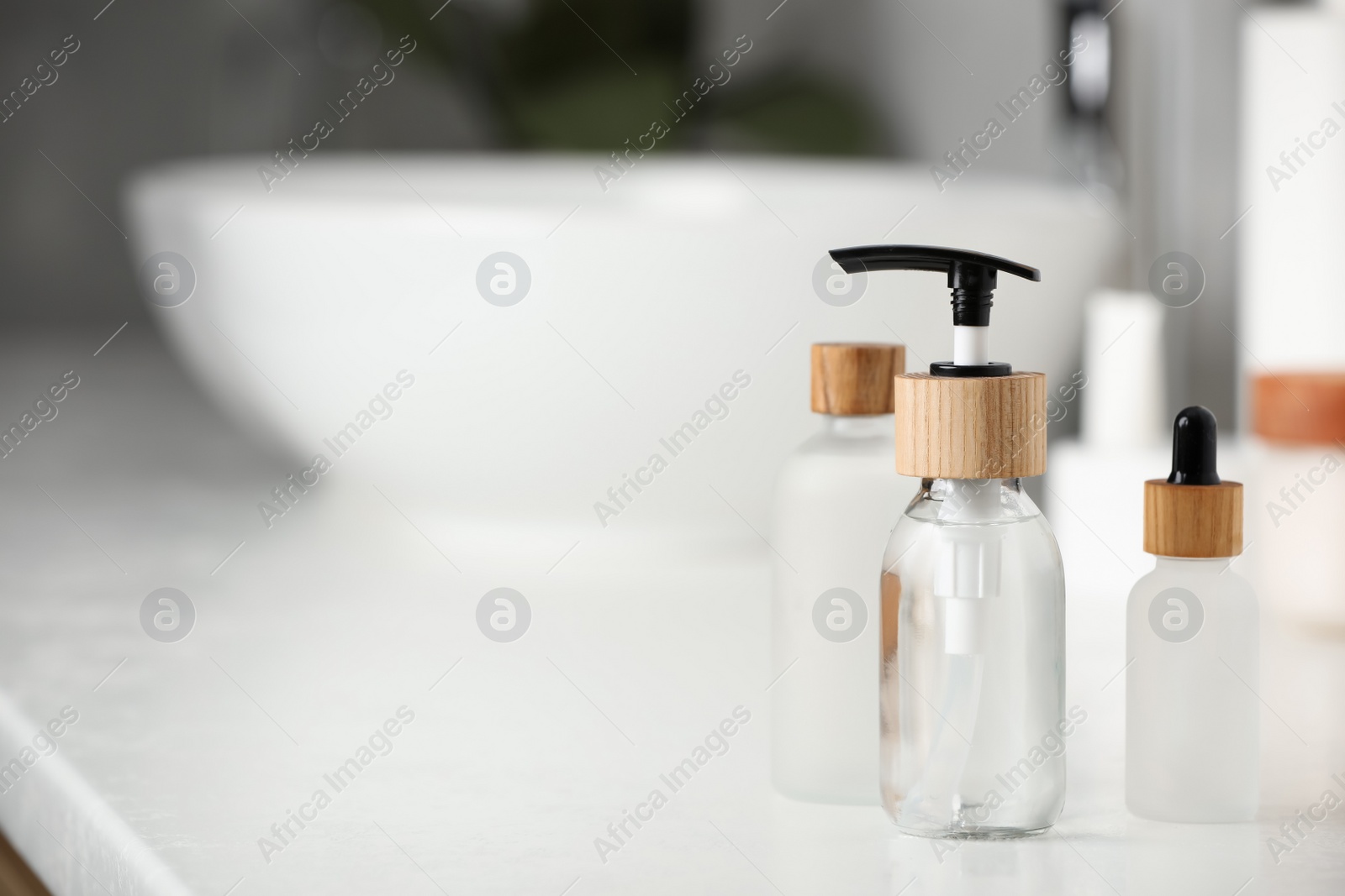 Photo of Different personal care products on countertop in bathroom. Space for text