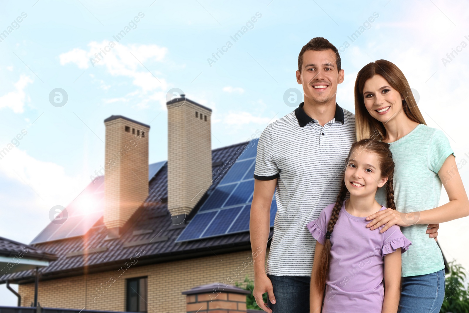 Image of Happy family near their house with solar panels. Alternative energy source