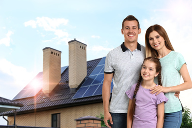 Image of Happy family near their house with solar panels. Alternative energy source