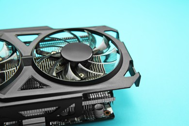 Photo of One graphics card on light blue background, closeup