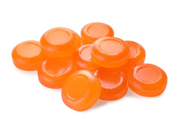 Photo of Many orange cough drops on white background