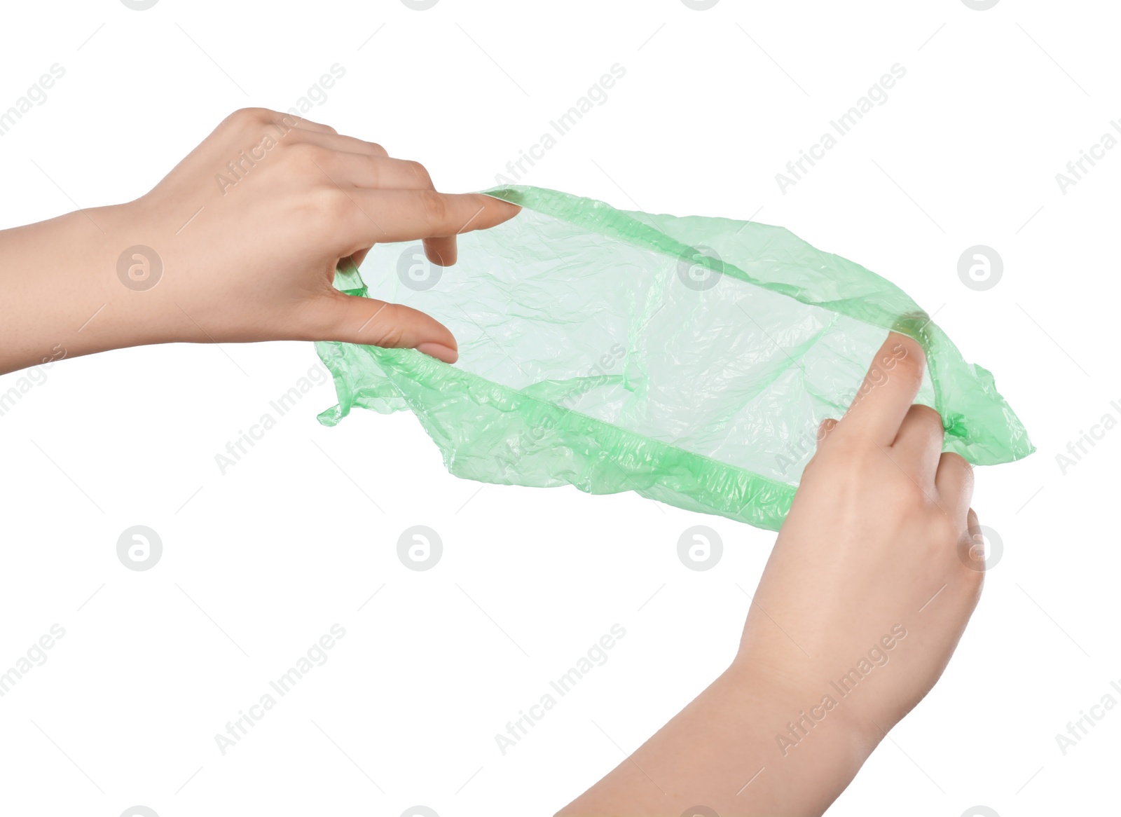 Photo of Woman holding green shoe cover on white background, closeup